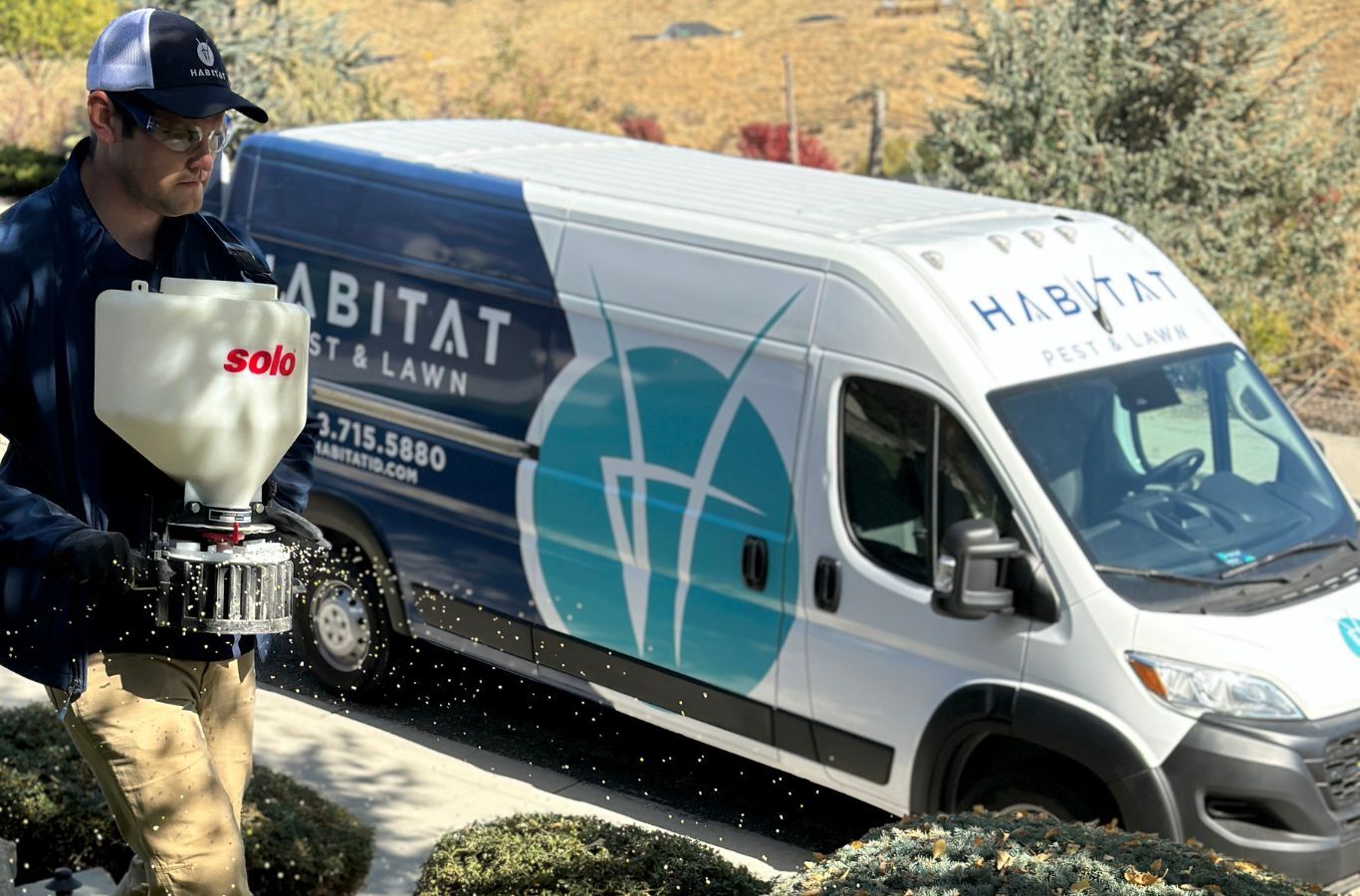 A Habitat Pest & Lawn technician performing pest control in Meridian, ID, ensuring a pest-free property with advanced tools.
